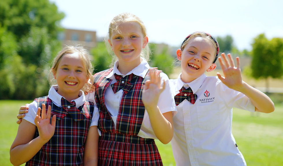 image of three students at nativity faith & reason catholic elementary school broomfield waving and smiling