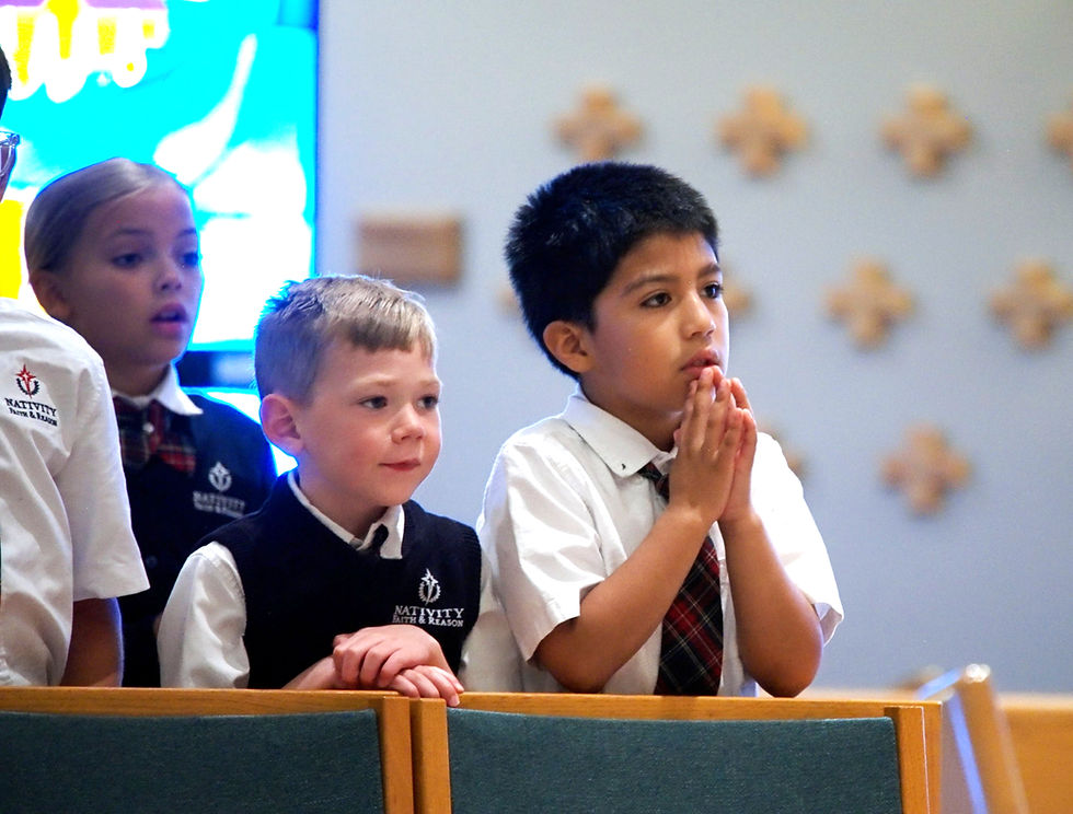 Students praying in school mass at nativity faith and reason catholic school broomfield